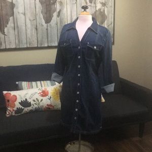 Knee length denim dress closes in front with snaps